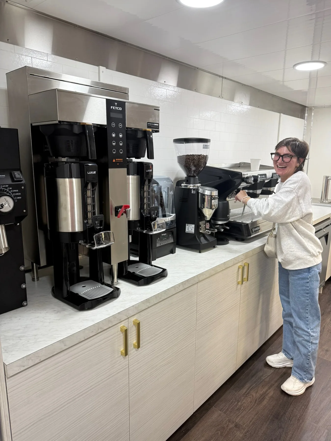 A barista working at the espresso machine inside the coffee truck