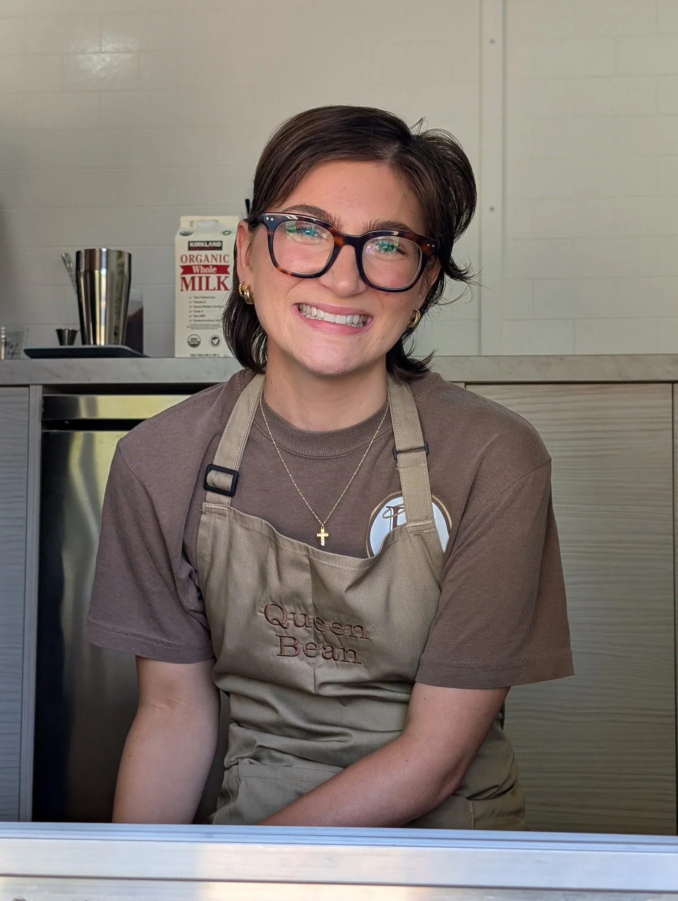 Olivia smiling from the Holy Grounds Coffee Truck service window